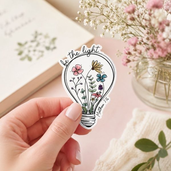 Matthew 5:16 flower lightbulb sticker in cozy pastel setting, uplifting Christian accessory with botanical design