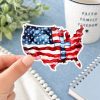 Faith-based USA flag sticker in cozy neutral setting, red white and blue Christian vinyl decal celebrating freedom and faith