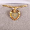 Mustard seed heart gold necklace placed in Majesty box