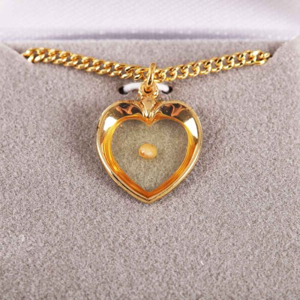 Mustard seed heart gold necklace placed in Majesty box