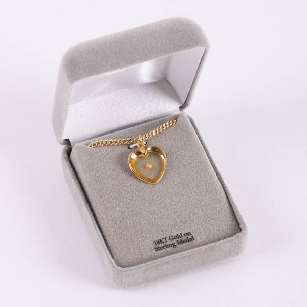 Mustard seed heart gold necklace placed in Majesty box