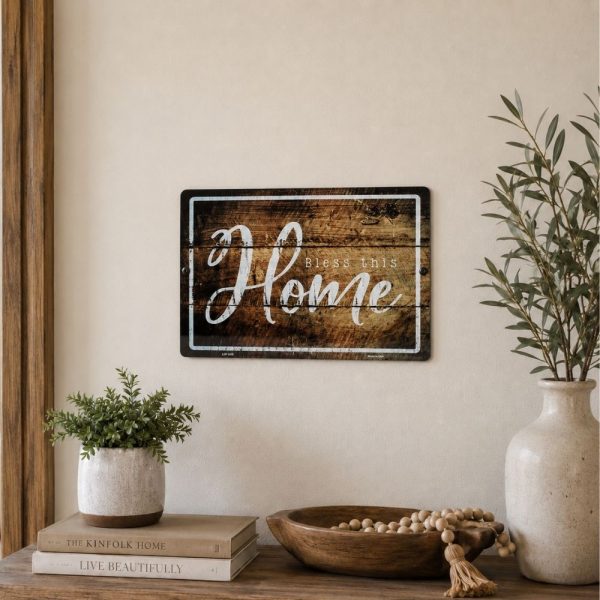 Bless This Home metal wall sign displayed above an entryway table, Christian farmhouse decor, faith-filled home decoration, religious wall art, inspirational family sign, rustic Christian home accent, welcoming faith-based decor.