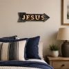Jesus arrow wall sign displayed above a cozy bedroom, Christian bedroom decor, faith-inspired wall art, religious home decoration, Jesus-themed metal sign, inspirational Christian room accent, rustic faith-based decor.