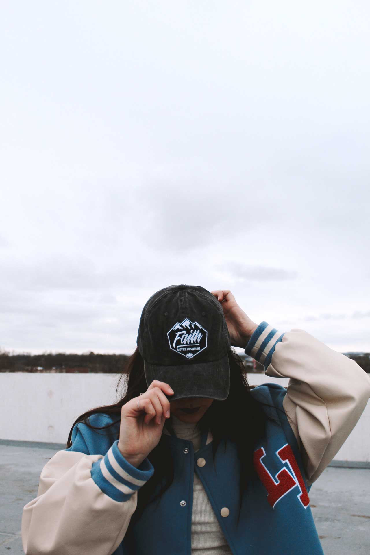 Girl wearing faith can move mountains hat swanson christian products