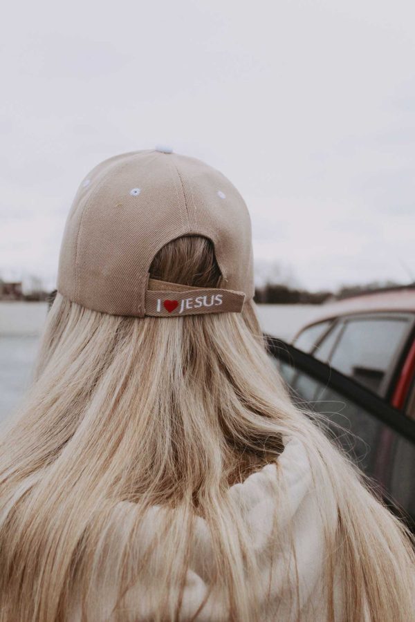 I love Jesus back of tan Christian baseball cap on girl