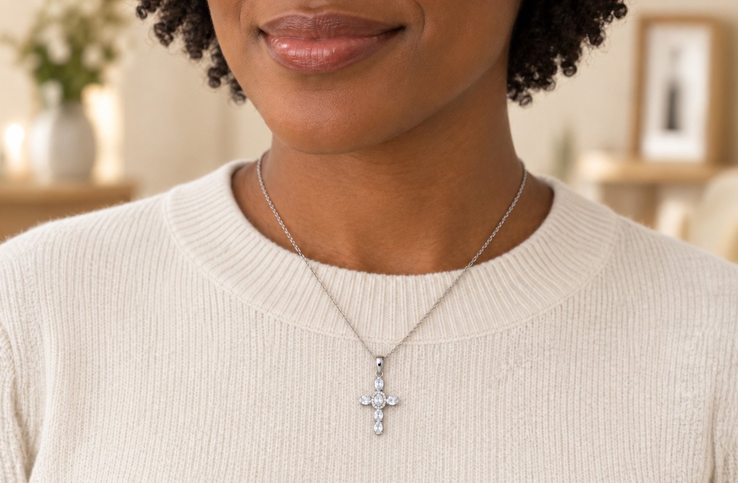 girl wearing silver cross necklace and white short