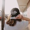 front view of girl wearing one way Jesus Christian black hat