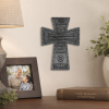 Godfather wall cross handing on a wall near a picture frame with an elderly man holding a young boy