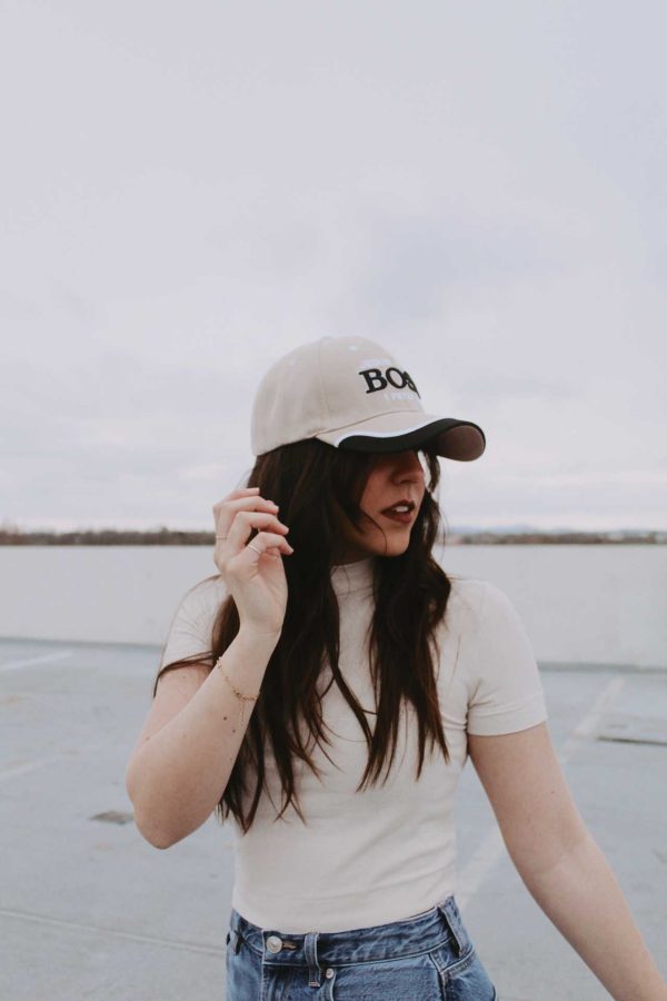 Girl wearing side view of Jesus is my boss hat swanson christian products