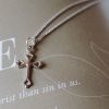 Beautiful gold-tone cross necklace resting on a page featuring the word “LEAH” and the phrase “God’s Faithfulness,” creating a soft and elegant devotional setting. The delicate cross design and warm gold finish symbolize faith, hope, and spiritual encouragement, making it a meaningful gift or everyday expression of Christian belief.