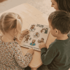 Mom and two children working on life of david wooden puzzle