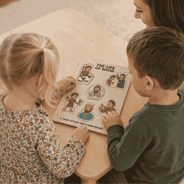 Mom and two children working on life of david wooden puzzle