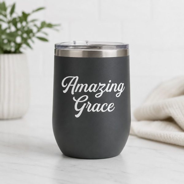 Dark gray insulated tumbler featuring a white Amazing Grace Christian vinyl decal, faith-inspired drinkware with elegant script lettering.