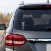 White faith-based vinyl decal featuring a combined symbol of a menorah, Star of David, and Ichthys (Christian fish) displayed vertically on the rear window of an SUV. The design is shown as a clean white decal on dark tinted glass, photographed from the rear driver's-side angle in a realistic outdoor setting.